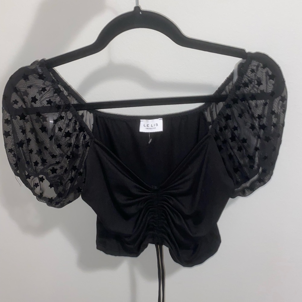 Black Le Lis top. Sheer star puff sleeves. Front tie. Size small.